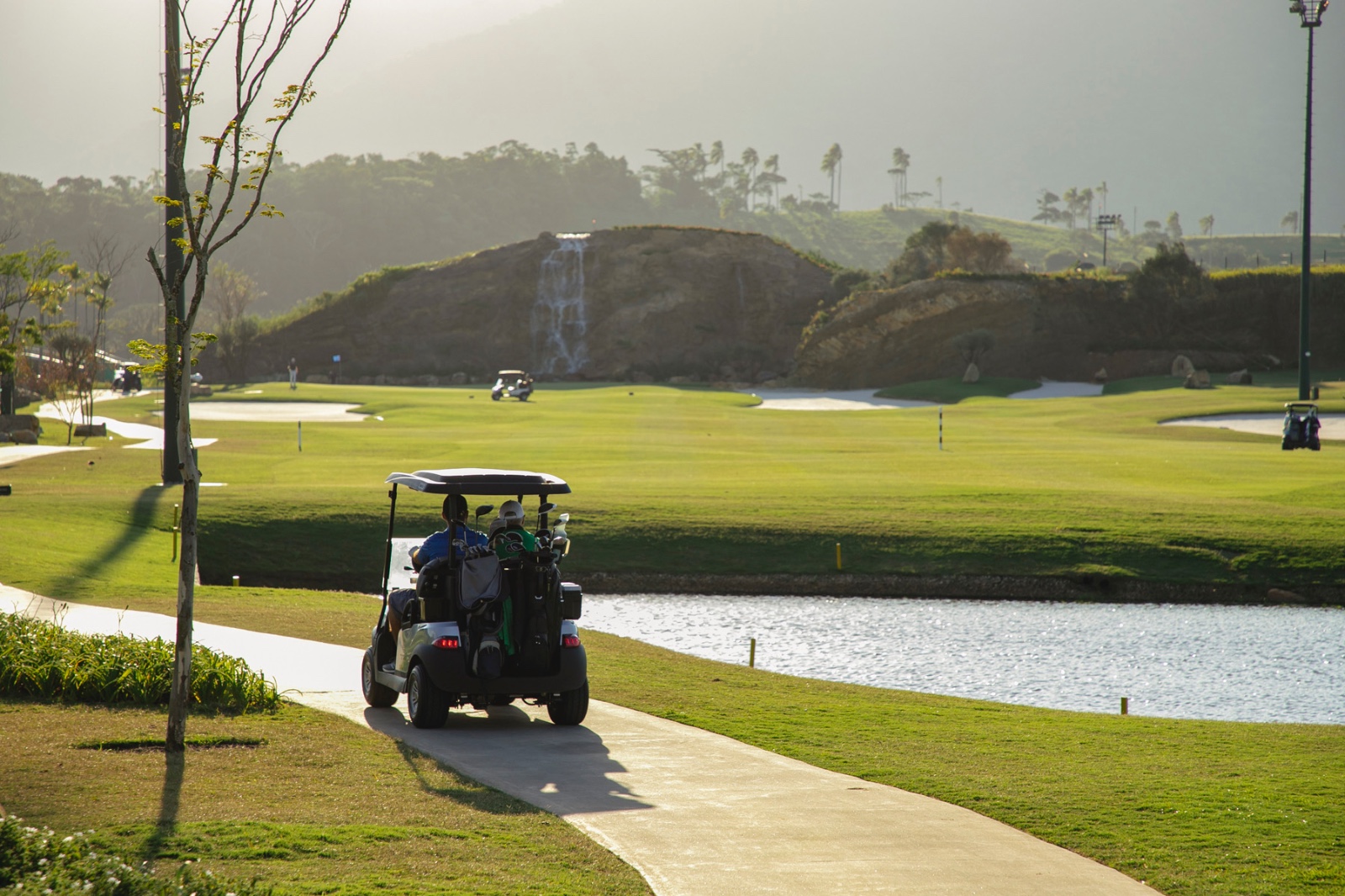 日中のPorto Belo Golfのコース。人工滝を配した丘陵とフェアウェイ、池が広がる